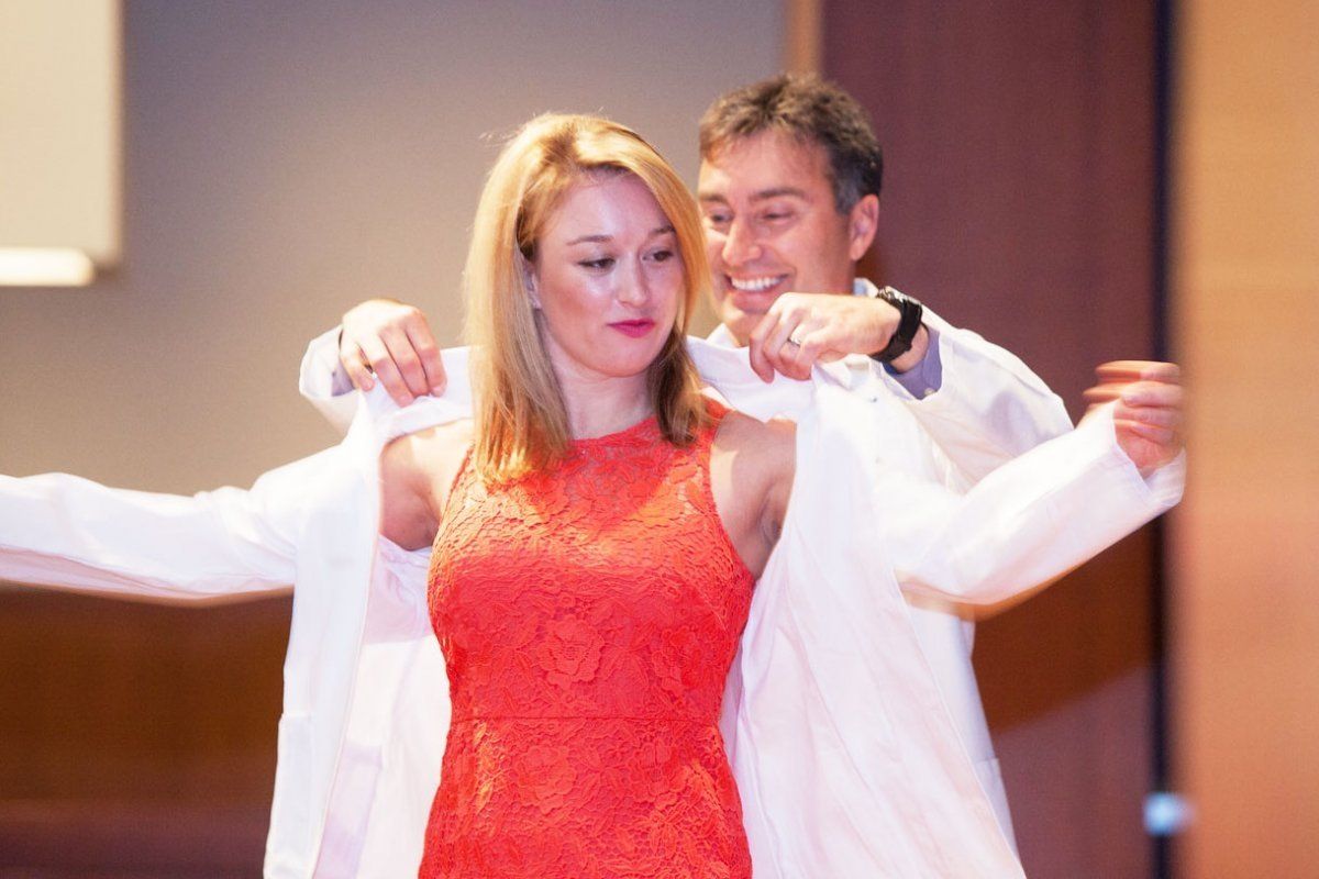 student receives her white coat
