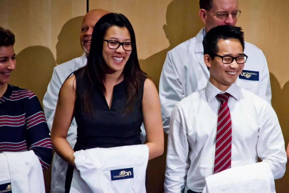 Students holding white coats