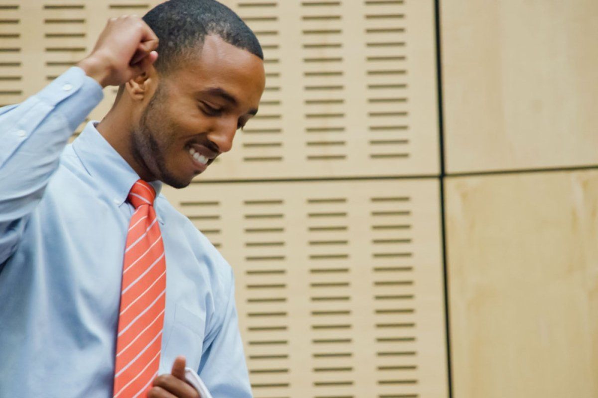 Student fist-pumping during white coat ceremony 