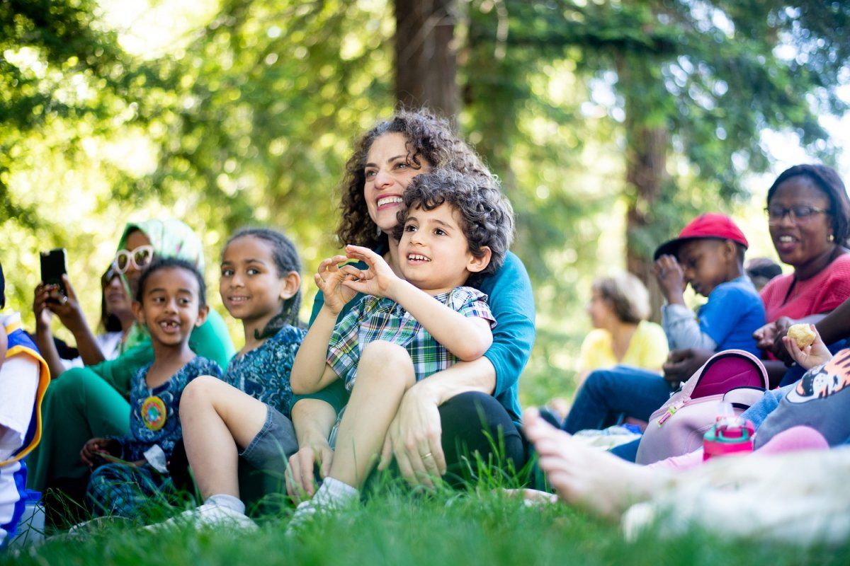 Nooshin Razani sits with her son in a park in Oakland during a Park RX event