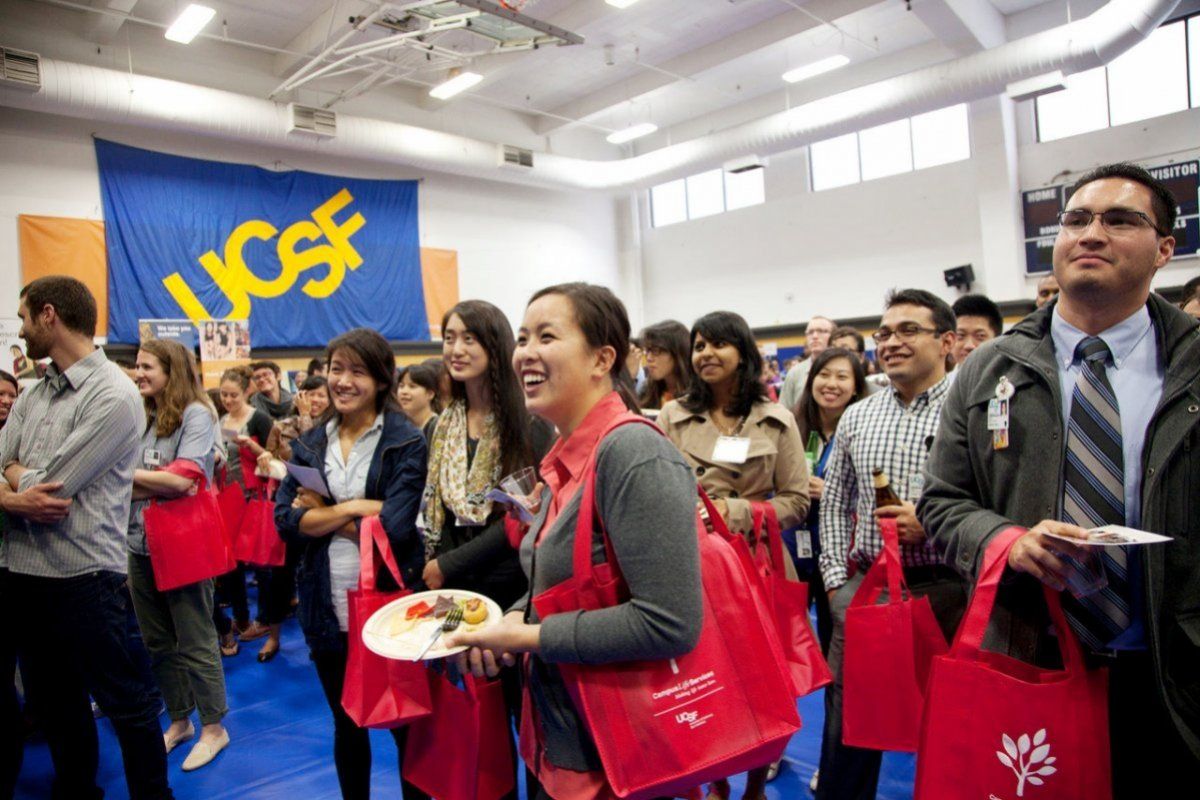 Group of students smiling at student fair