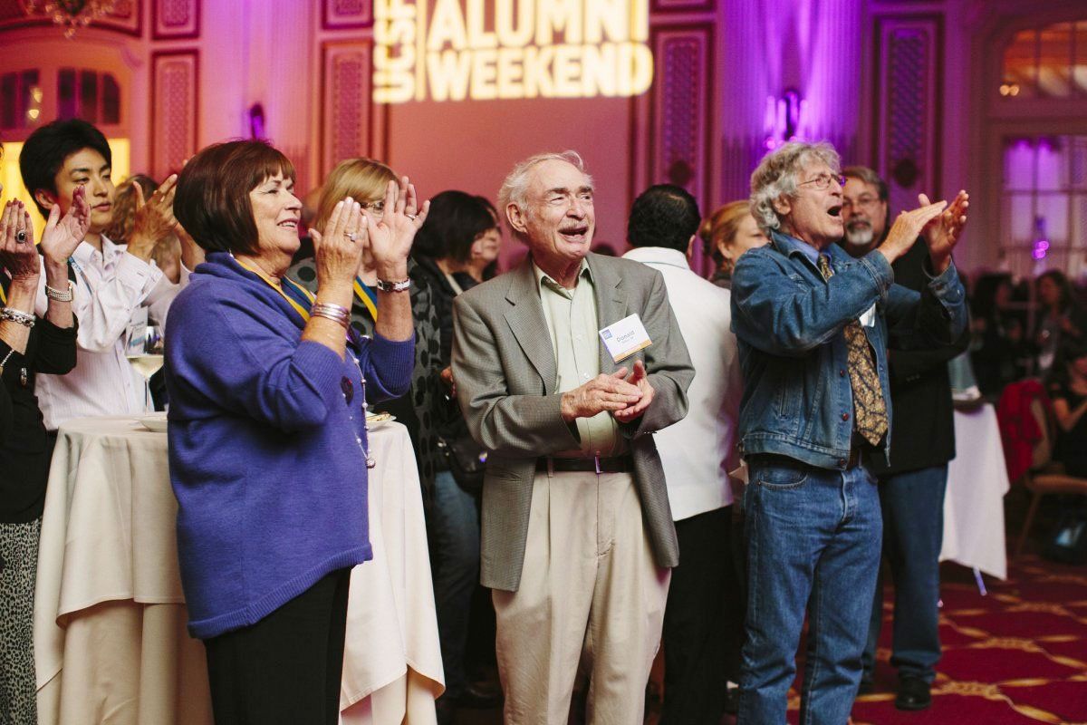 Older UCSF alumni clapping and cheering