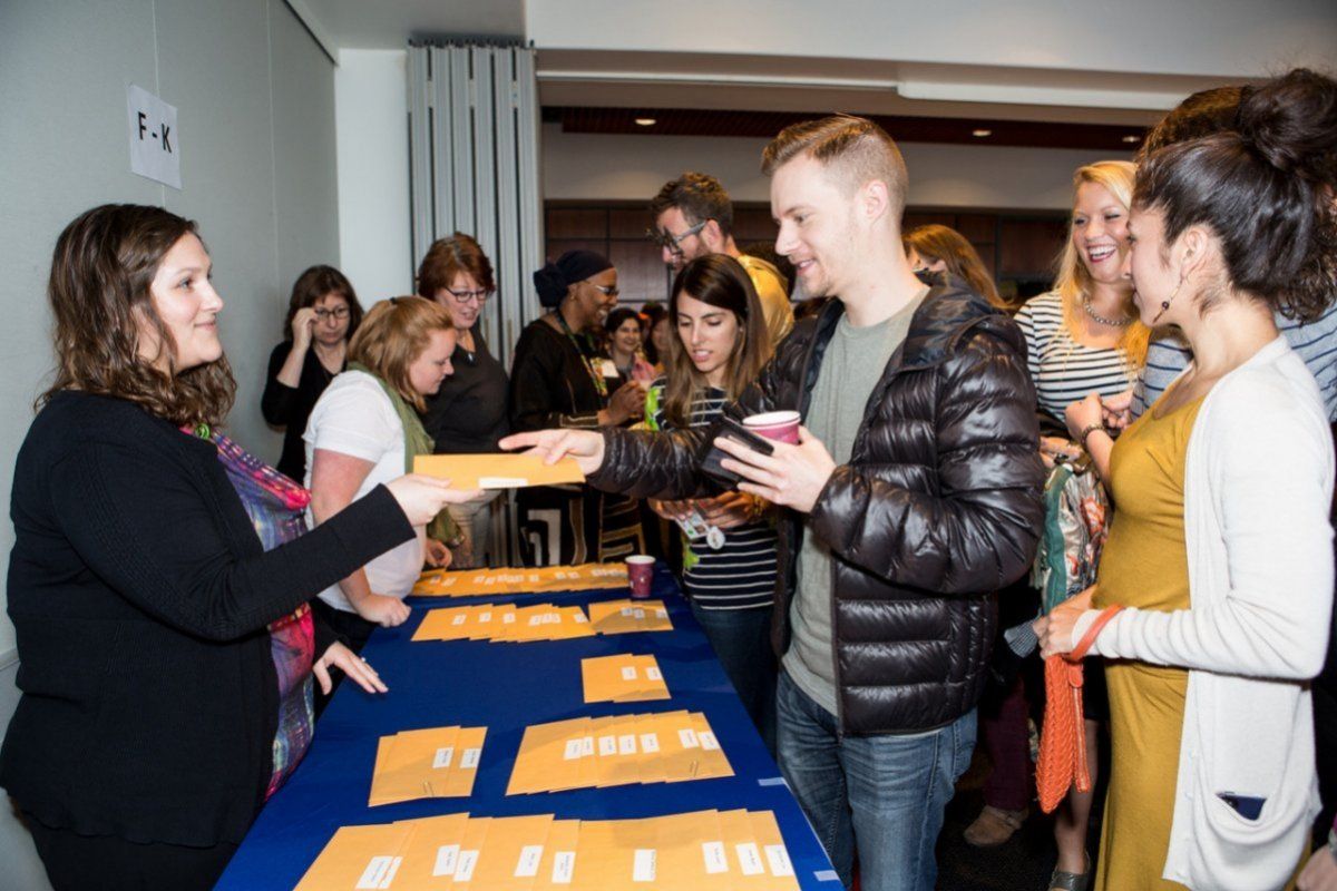 Student being handed envelope. 