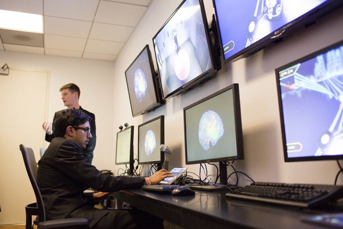 Students working on Digital scan of brain in neuroscience lab 