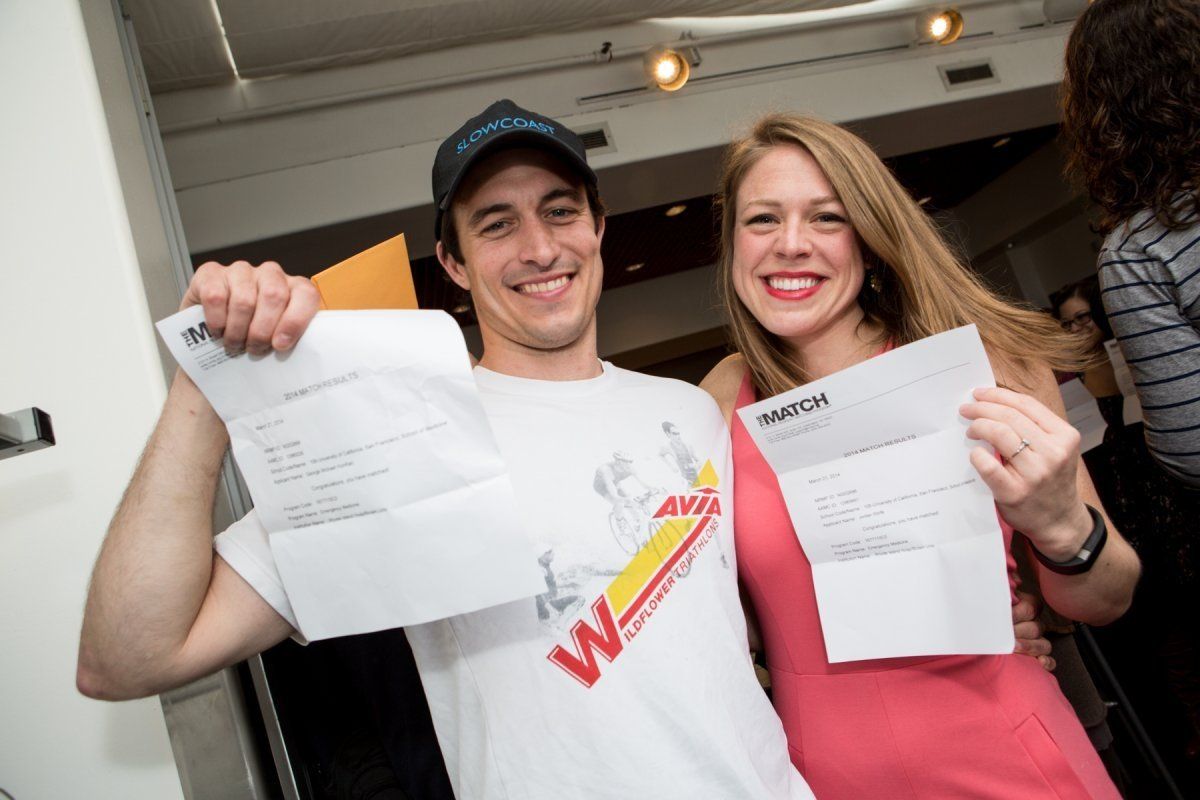 Two medical students smiling with Match papers