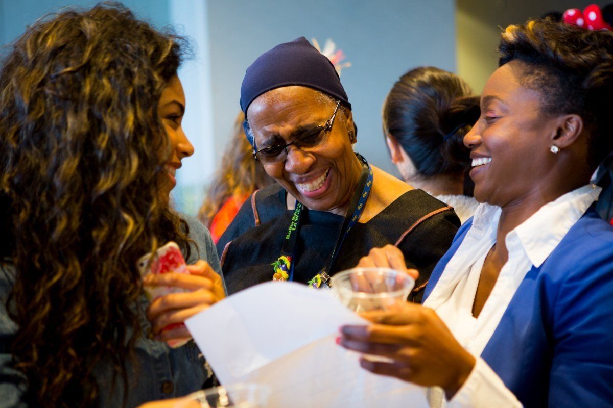 Three women smiling and talking 