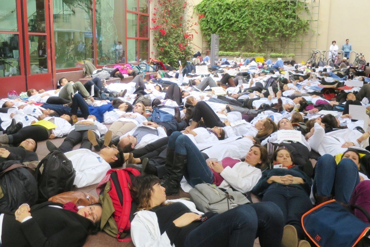 Medical students laying on the ground in protest