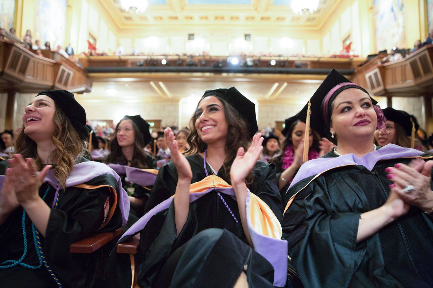 Students applaud during graduation ceremony