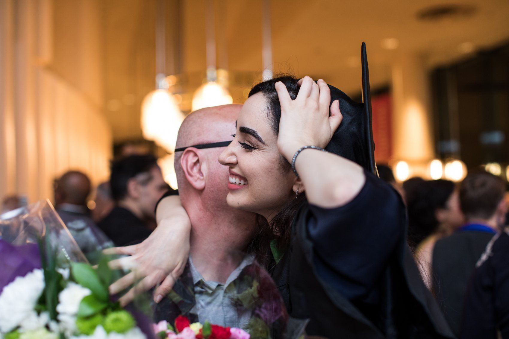 Two people hugging at SOM Commencement 2019