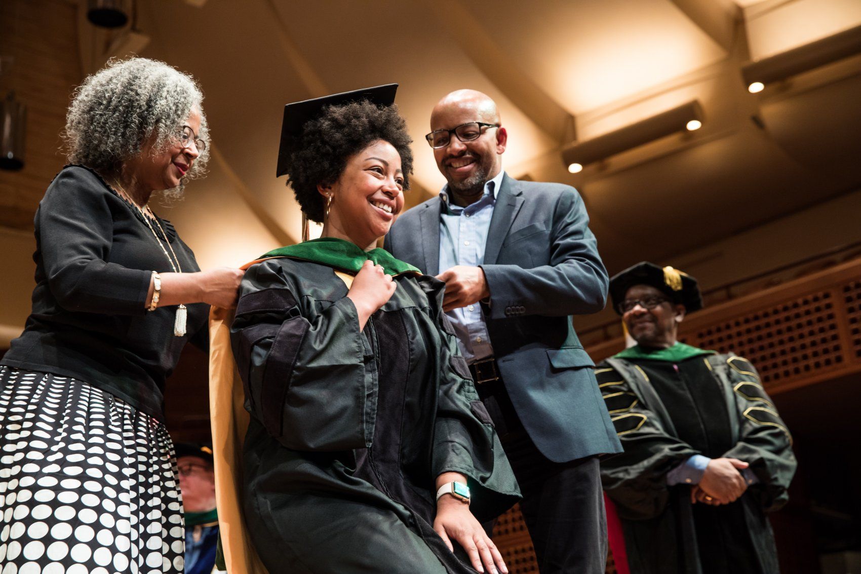 Jordan Hastie hooded by parents at SOM Commencement 2019