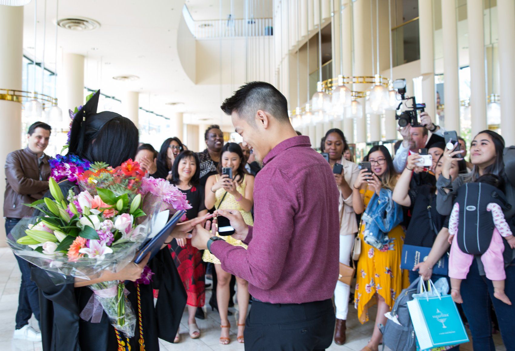 Man proposing to woman at graduation