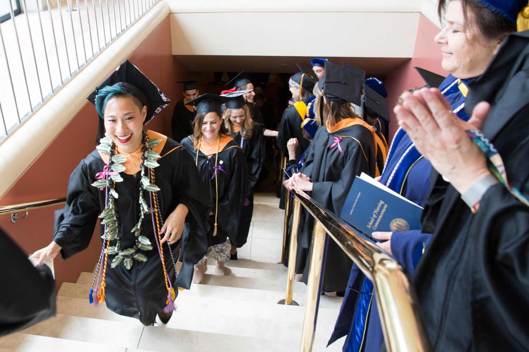 Graduating students walking up stairs