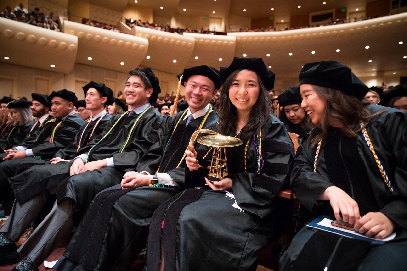 YeeAnn Chen holds the Bowl of Hygeia award at SOP Commencement 2019