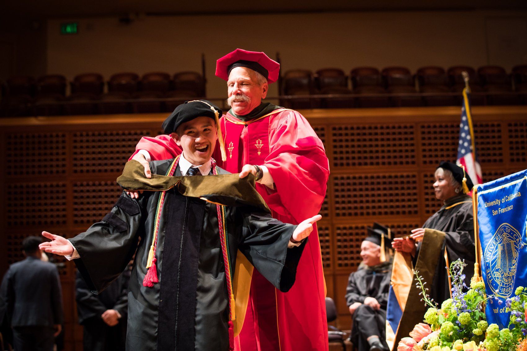 Dean Guglielmo hoods Drake Dinh at SOP Commencement 2019