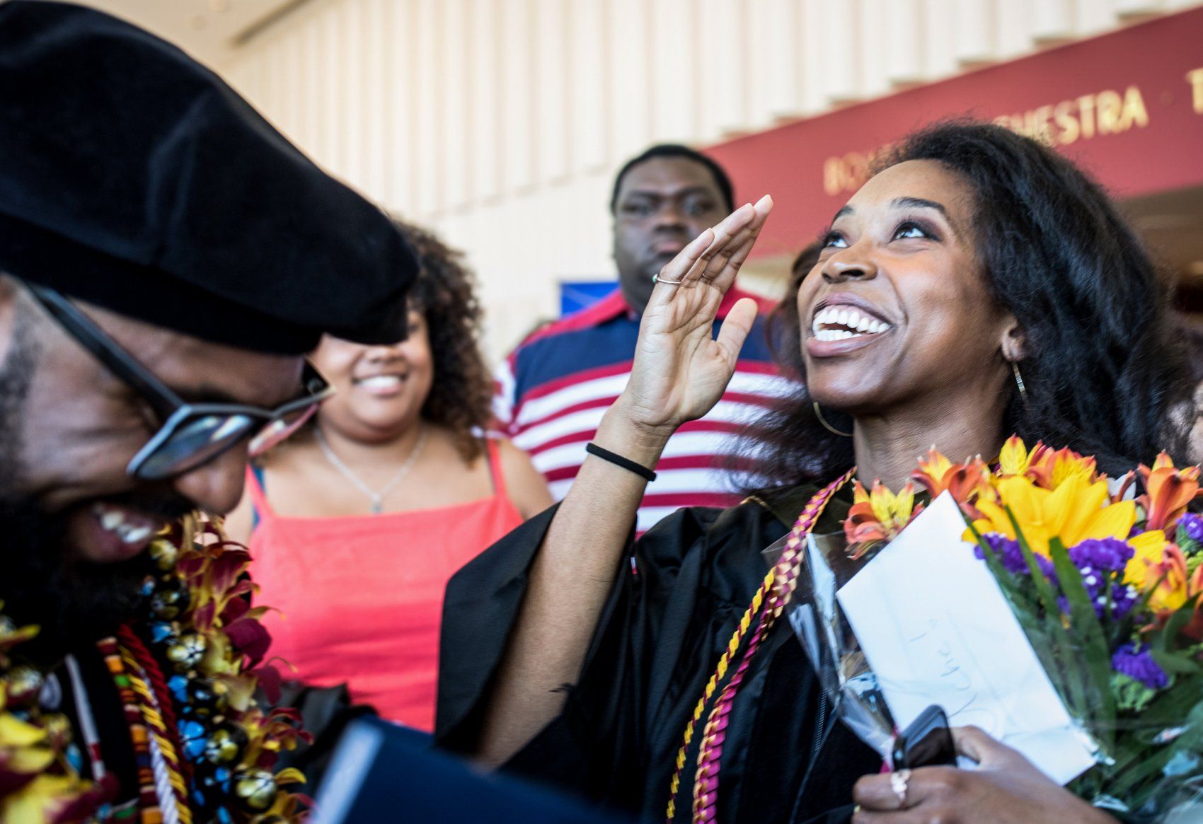 Two graduating students laugh after SOP Commencement 2019