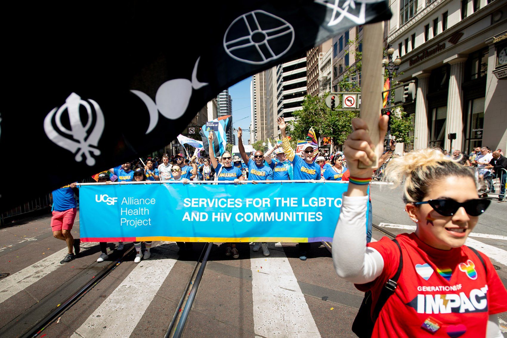 marchers walk down the street holding a banner
