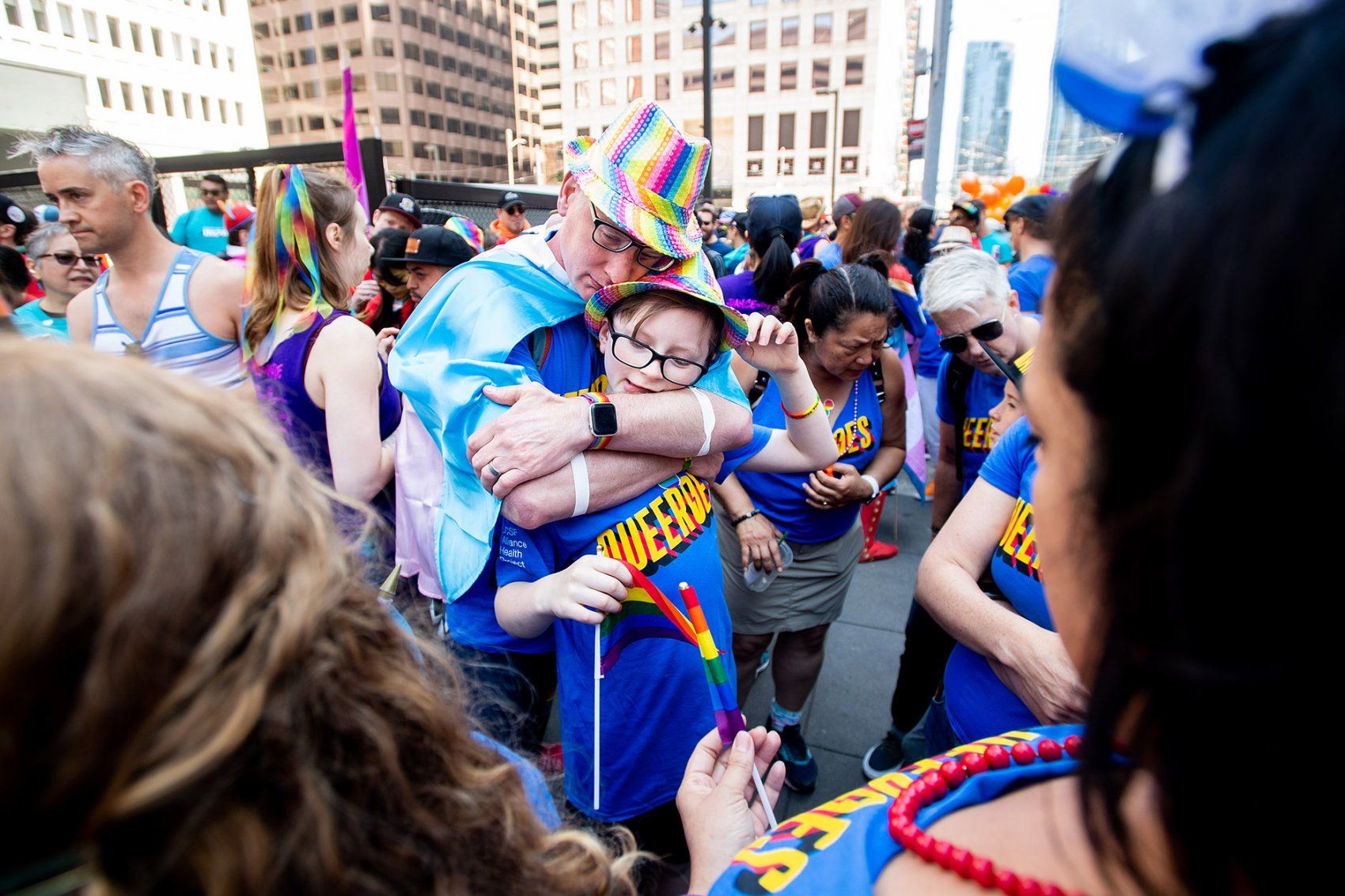 a father hugs his 10-year-old son