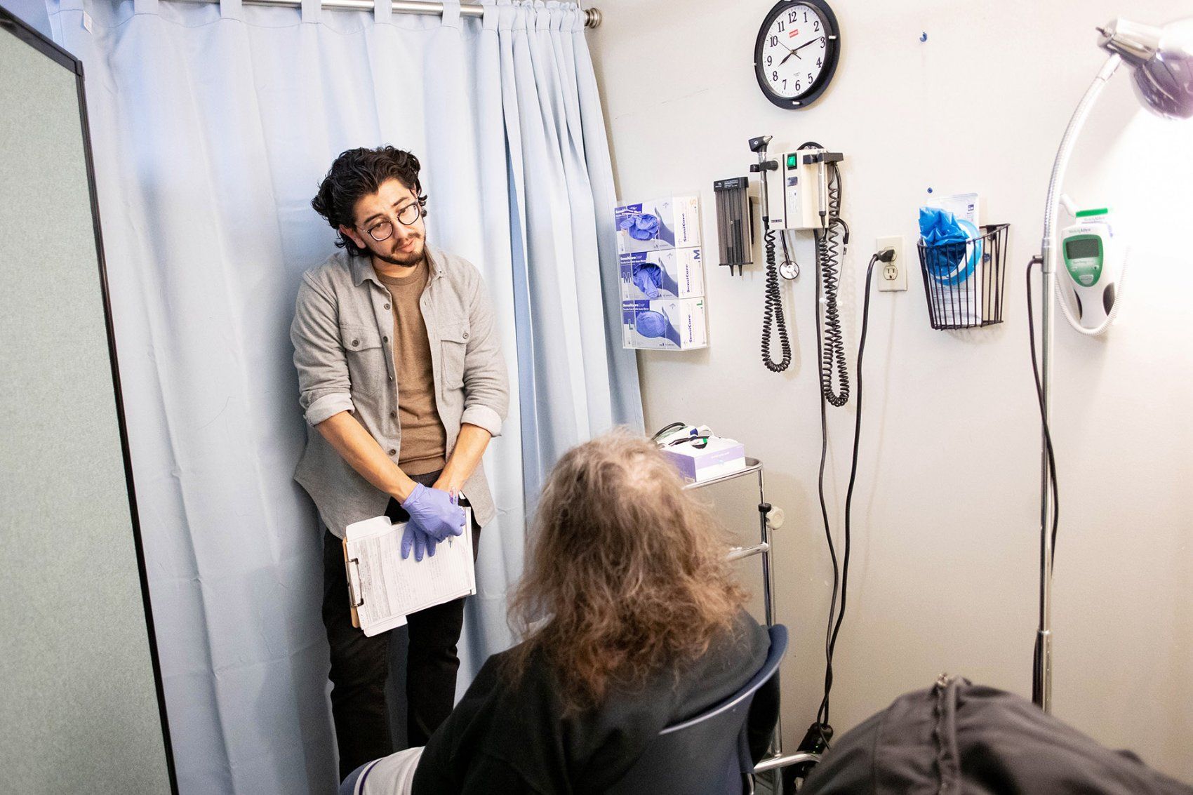 student doctor talks with patient