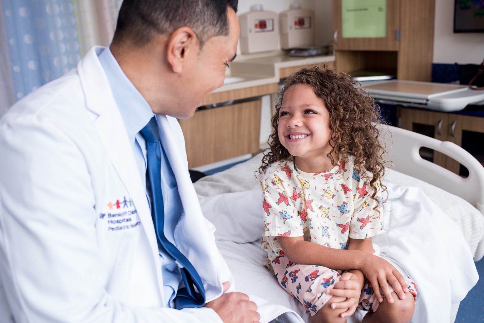 Doctor talks with smiling child