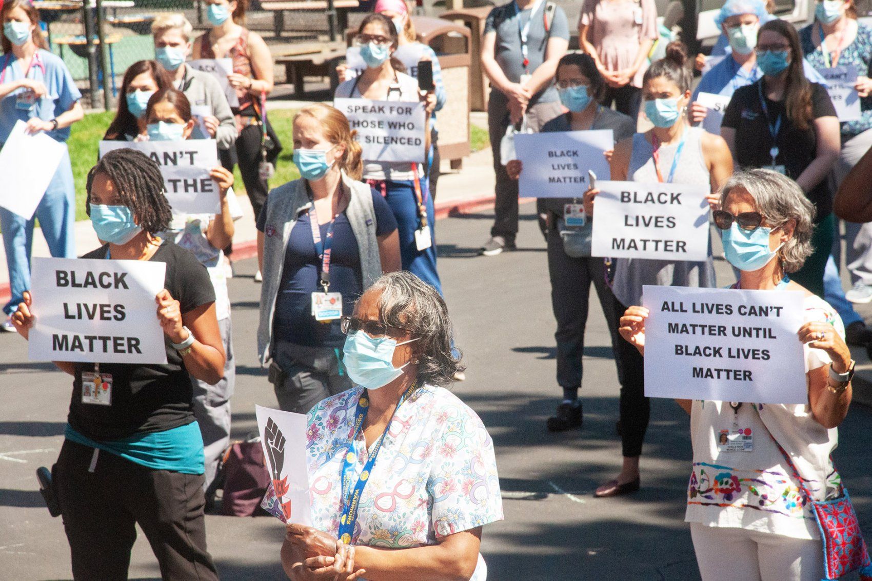 people hold Black Lives Matter signs during a rally at Benioff Children's Hospital Oakland