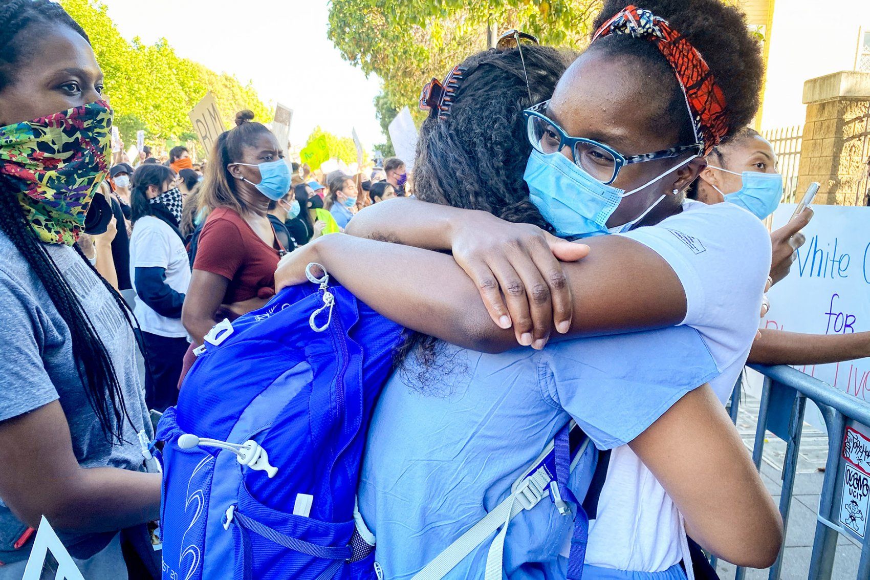two UCSF students hug during a rally in San Francisco
