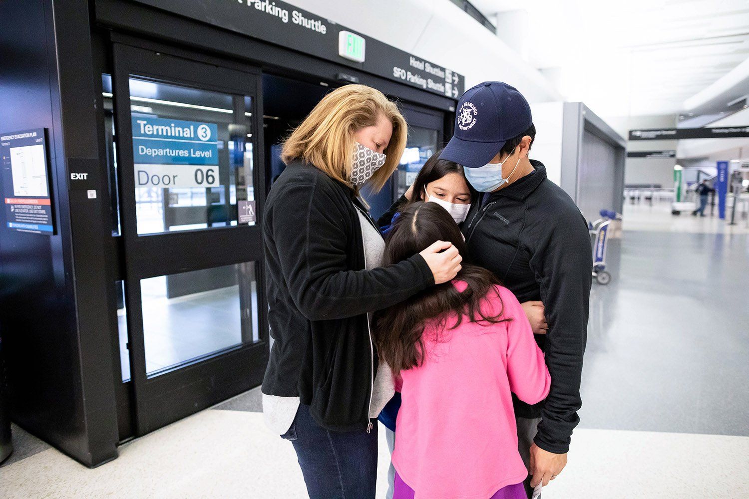 Clement Yeh hugs his family at the airport before taking off to NYC to help with patient care