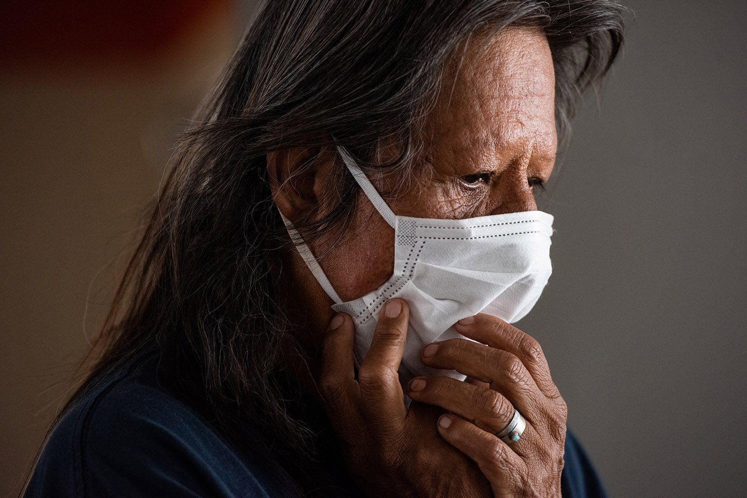 Brenda Beyal, a member of the Navajo Nation, adjusts her mask while quarantining at the Howard Johnson motel