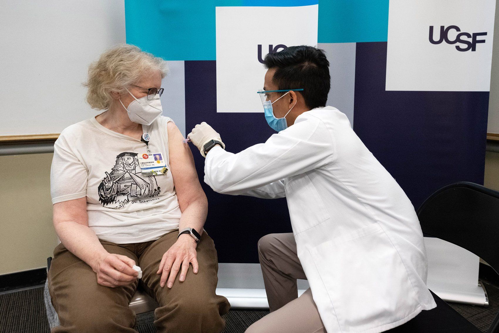 nurse receives a COVID-19 vaccination