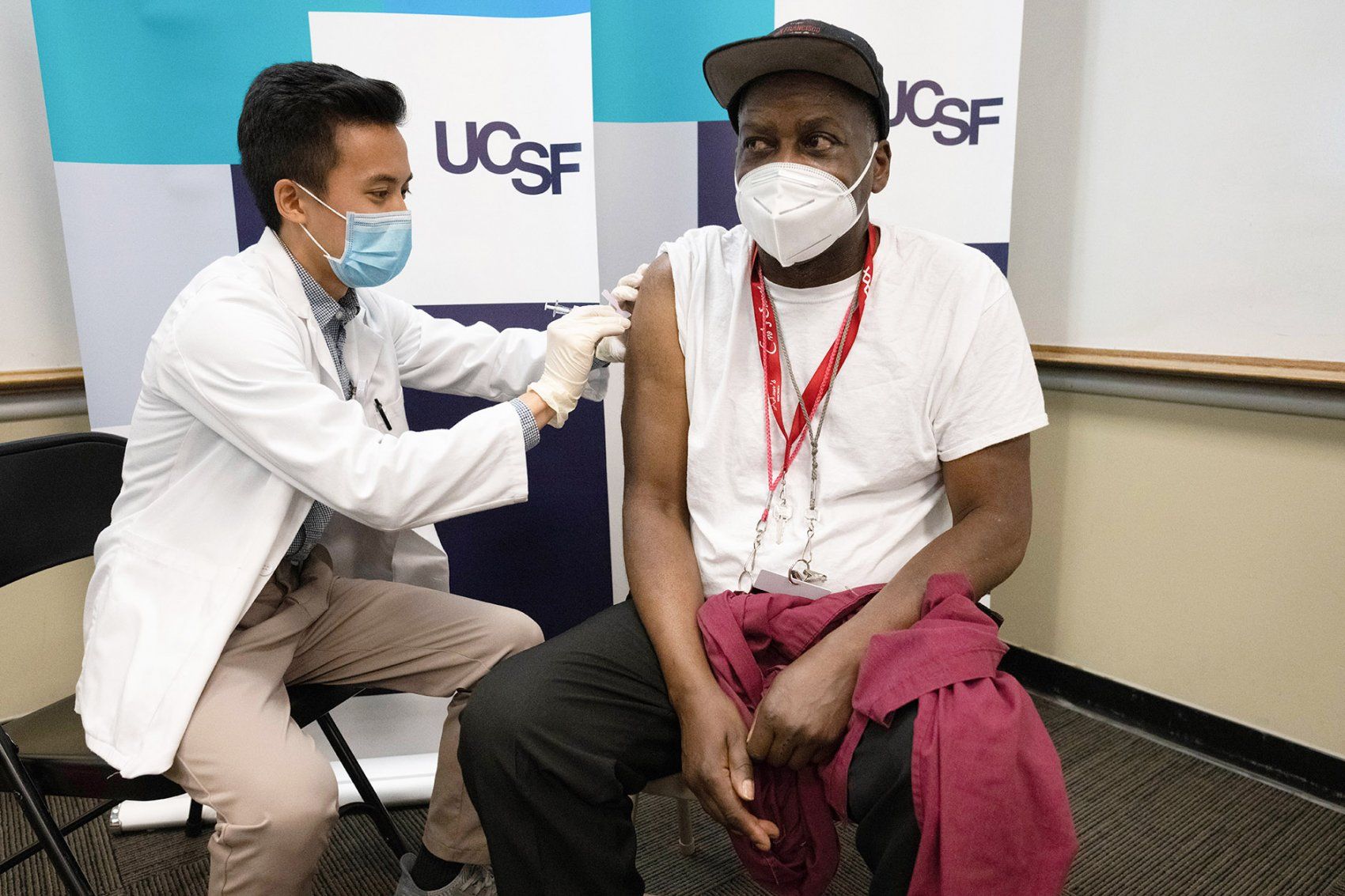 man receives COVID-19 vaccination shot