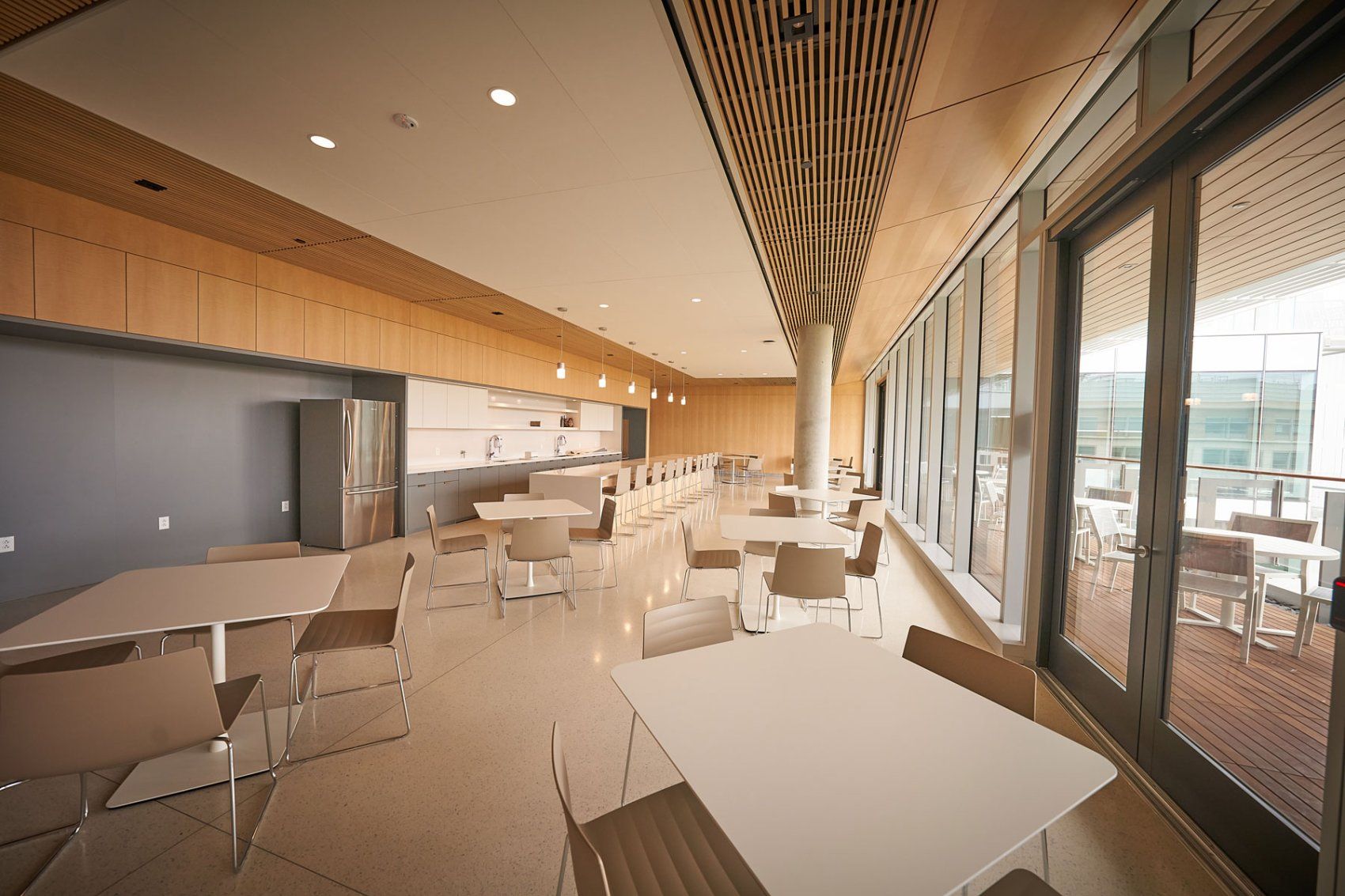 White tables and chairs in an eating area inside the Weill Neurosciences Building