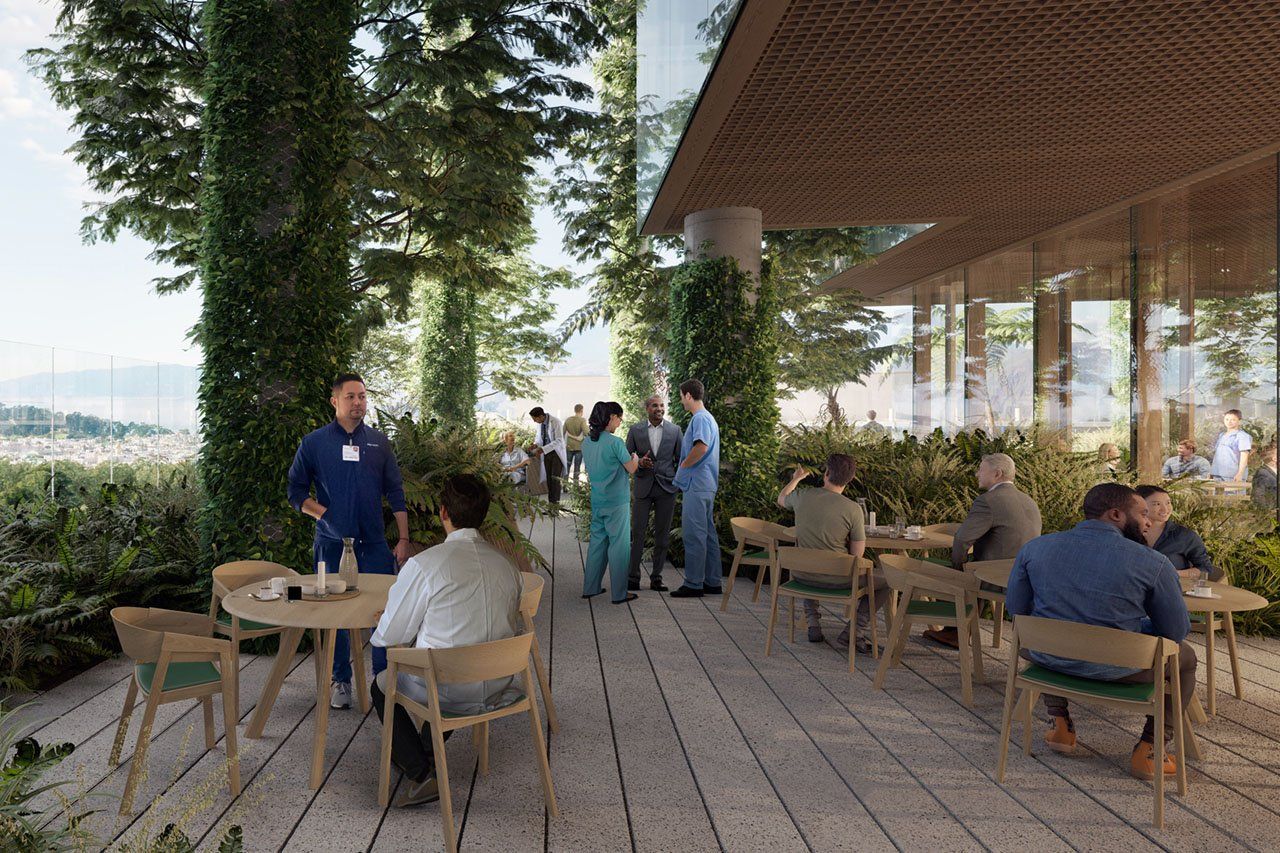 Patrons sit at outdoor tables on the tree-lined veranda with vistas past the balcony