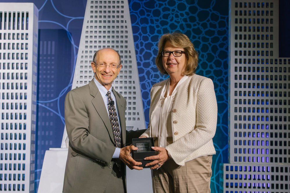 Dan Lowenstein (left) presents the Alumni Discovery Award to Janet Abrahm (right). Image by Sonya Yruel