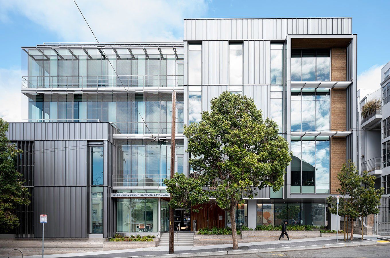 An exterior shot of the Nancy Friend Pritzker Psychiatry Building. A tree grows next to the entrance.