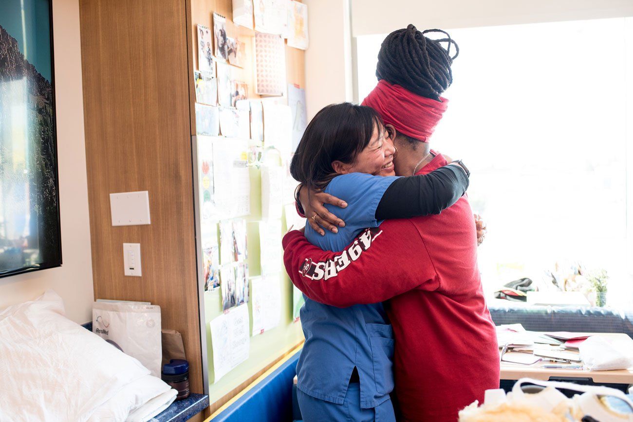 A pediatric nurse hugs the mother of a patient at UCSF Benioff Children's Hospital