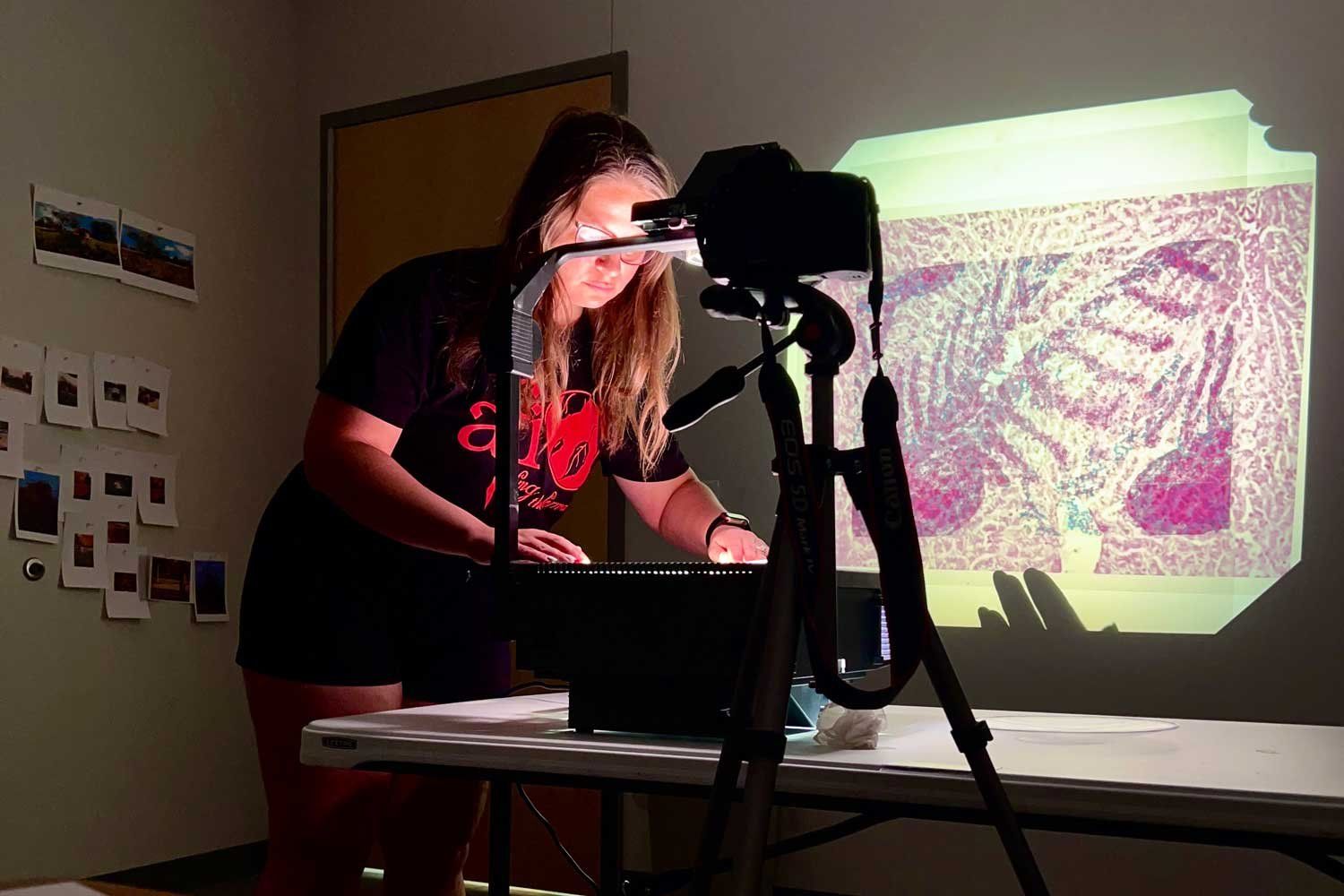 Katina Bitsicas arranges images on a projector for her newest immersive video installation.