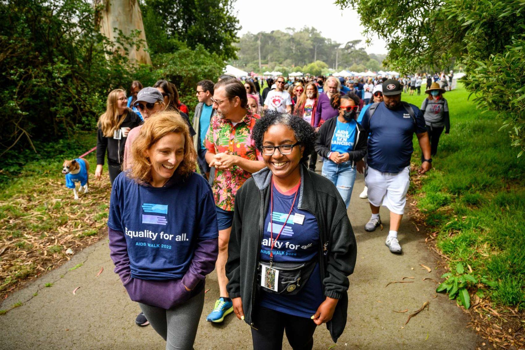 Two women leading a group of people walking 