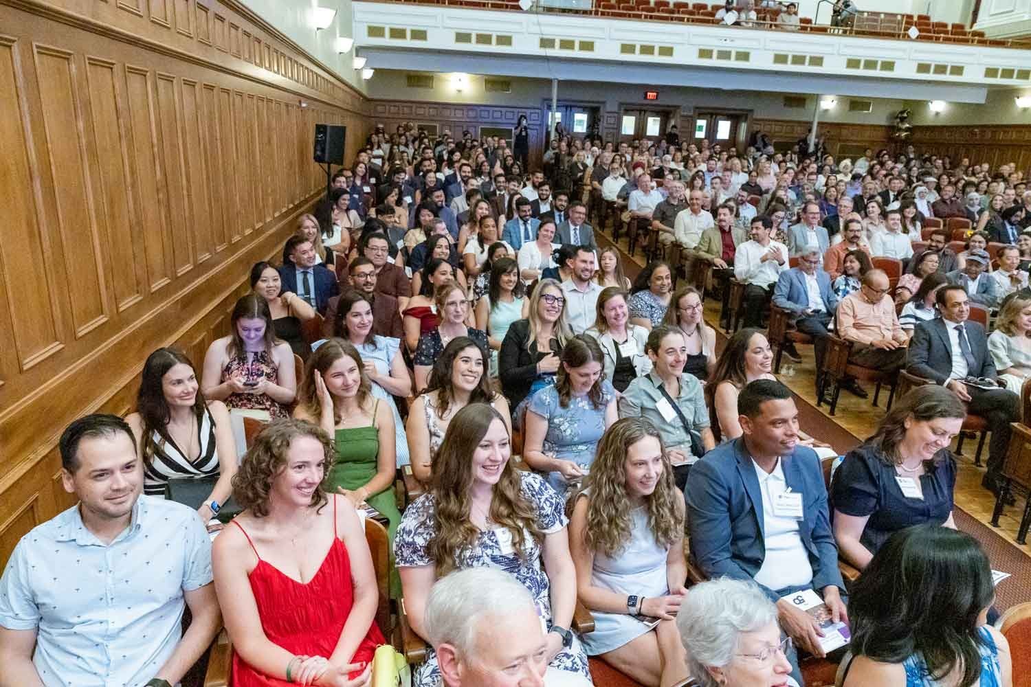 An auditorium filled with graduates and their guests.
