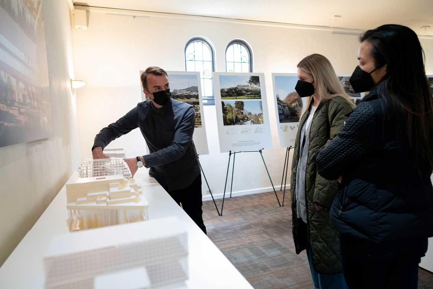 An architect shows 3D models of the new Parnassus Heights campus to local residents.