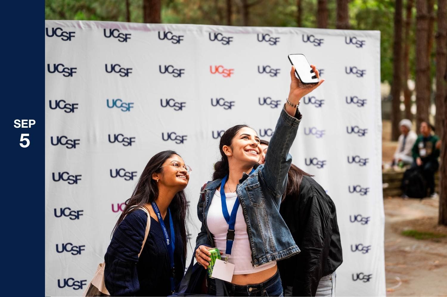 Students pose for selfies on campus.