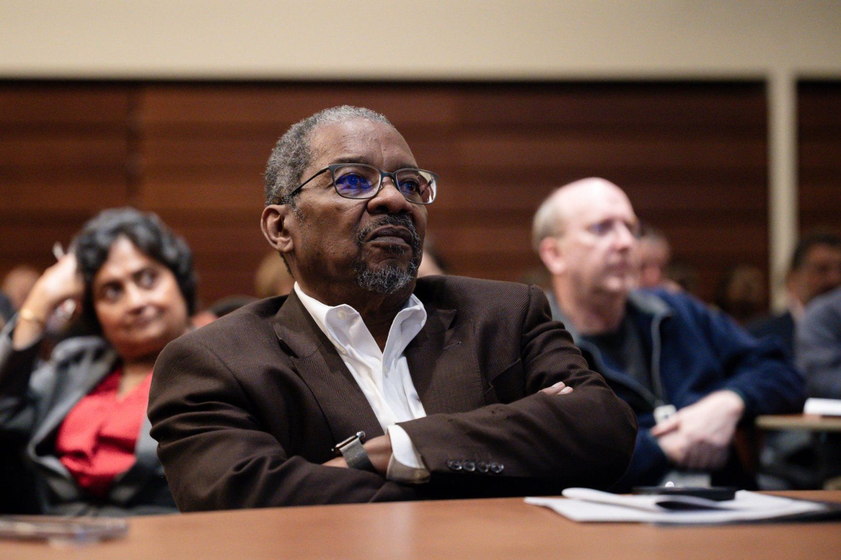 Dr. Talmadge King Jr. sits at desk in deep thought.