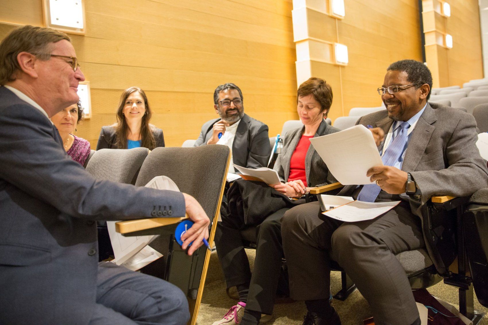 Dr. Talmadge King Jr. speaks with Chancellor Sam Hawgood and other group in classroom.