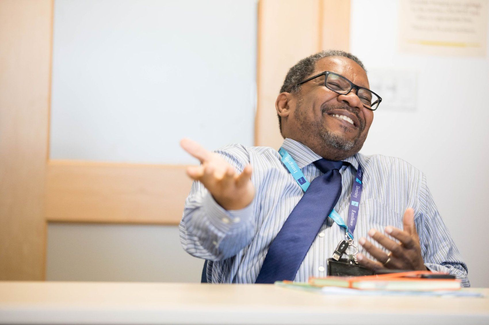 Talmadge King laughs at desk.