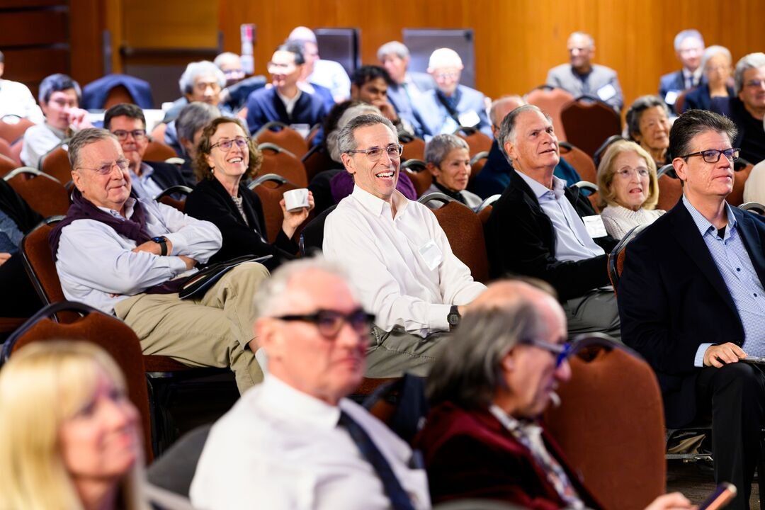 Community members sit in the audience at J. Michael Bishop's memorial.