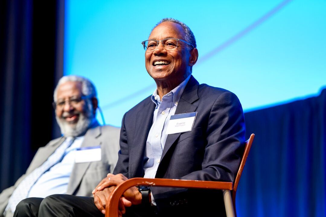 Gene Washington sits onstage at J. Michael Bishop's memorial.