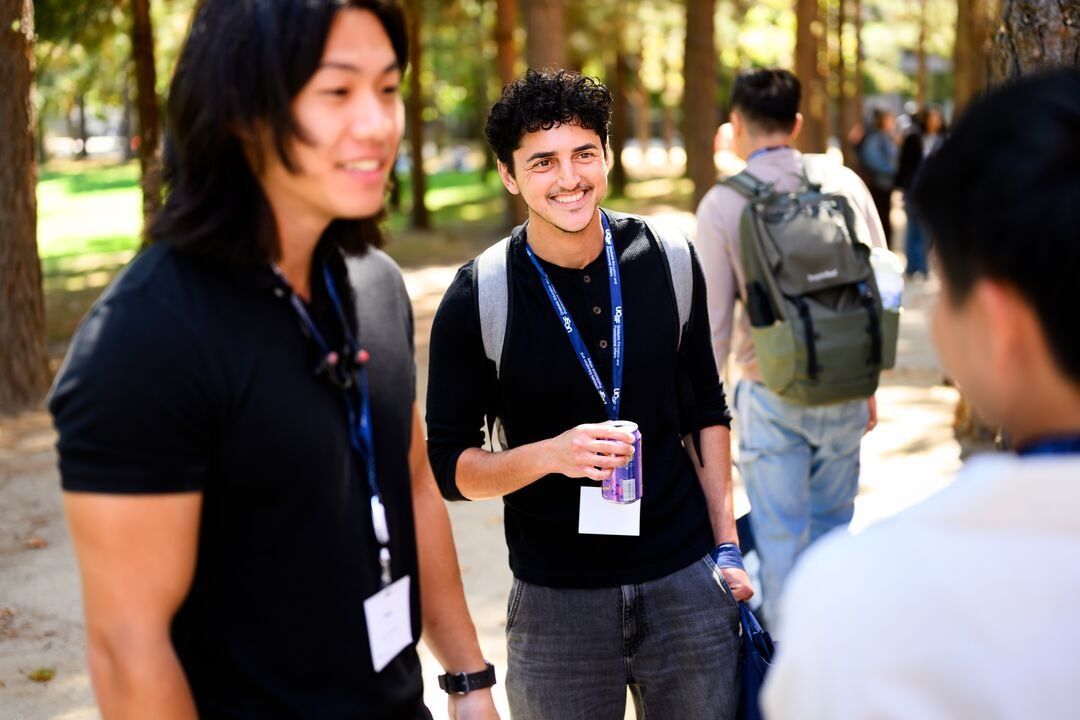 Students speak together outdoors.