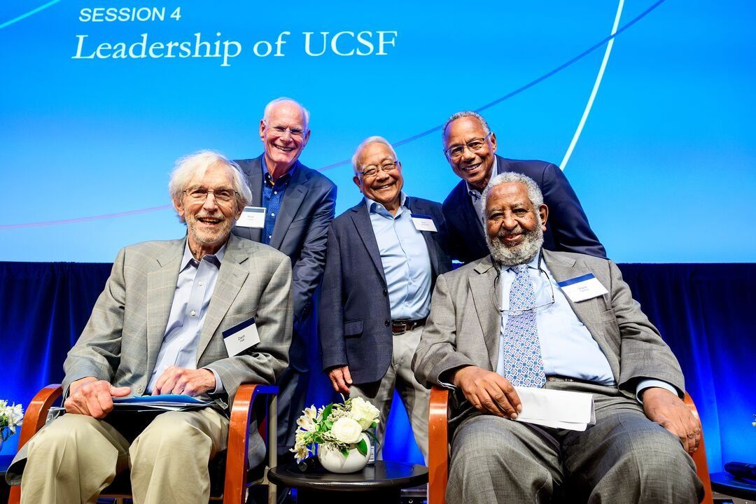 Five former leaders in a group shot on stage.