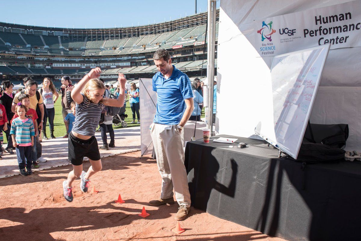 A girl in the midair as she participates in the long jump competition