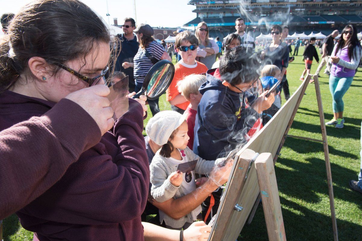 a girl looking through the magnifying glass