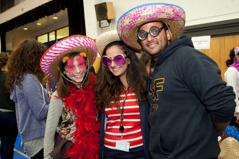 students Lauren Frisch, Hengameh Jannati, and Daniel Keyvani pose for a photo in funny glasses and hats