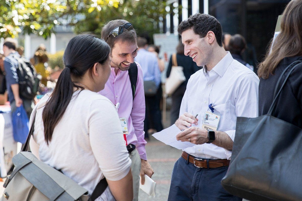 UCSF faculty Margaret Lin, MD, Scott Fruhan, MD, and Eric Silverman, MD, are having a conversation during Faculty Development Day
